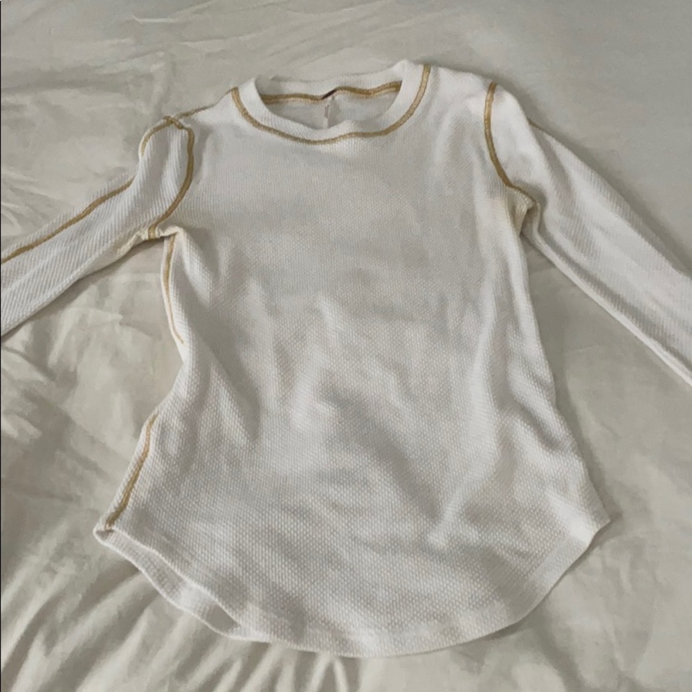 white thermal top with gold stitching